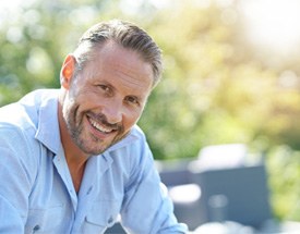 smiling man with dental bridge in Canton