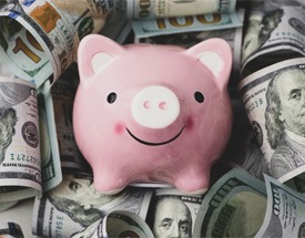 Piggy bank on pile of money 