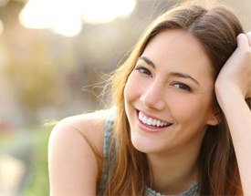 patient smiling after getting dental crown in Canton 