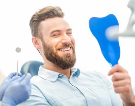 man smiling after getting dental crown in Canton	