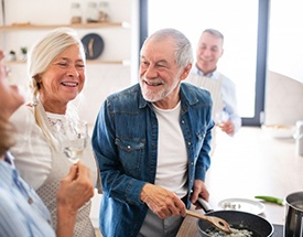 Patient with dentures in Canton talking with family