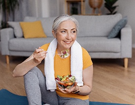 Patient with dentures in Canton eating healthy