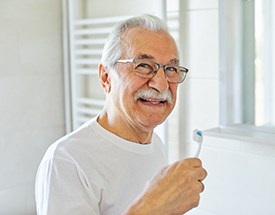 Patient in Canton brushing their dentures