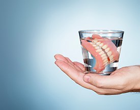 Dentures soaking in a glass