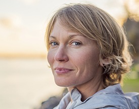 Older woman smiling outdoors