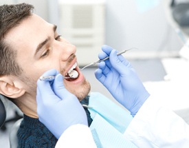 Man with dental implants in Canton visiting dentist for checkup