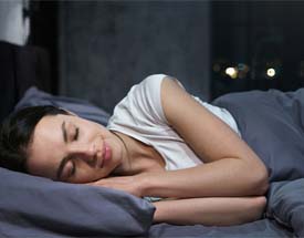 woman sleeping after dental implant surgery in Canton