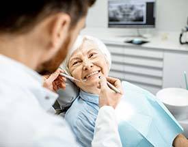 senior woman smiling at her dentist 