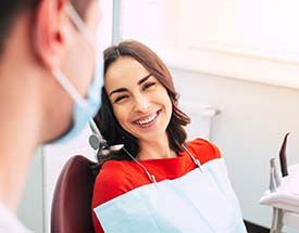 young woman smiling with her dentist 