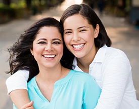 Two woman smiling outdoors