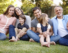 Smiling family posing outdoors