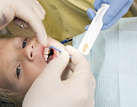 Child receiving fluoride treatment