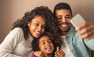 Smiling parents and daughter