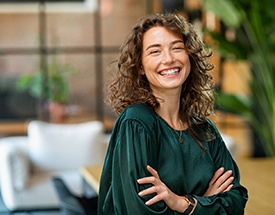 a smiling woman with her arms crossed