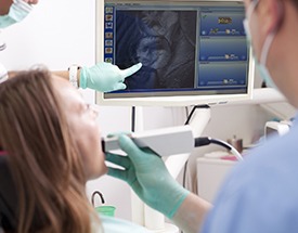 Dentist and patient looking at intraoral photos