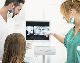 Dentist and patient looking at dental x-rays