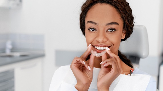 Woman with white teeth and hand on cheek