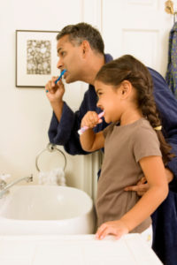 father and daughter brushing teeth with tips from their dentist in hickory flats