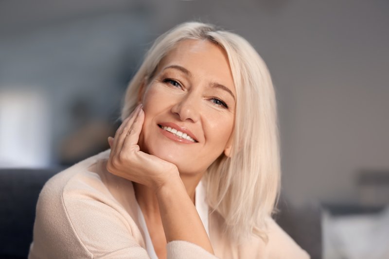 older attractive woman happy with her dental implants