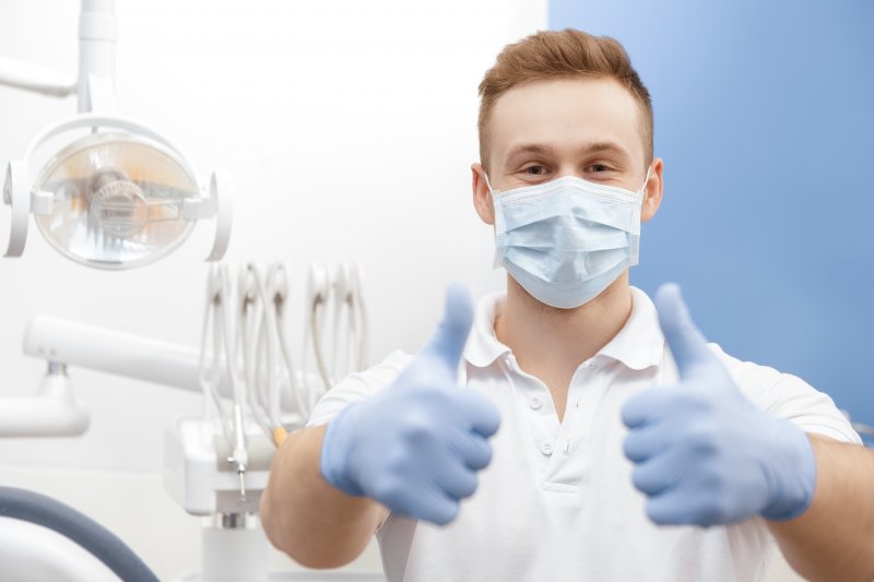 Dentist gives thumbs-up with gloves   