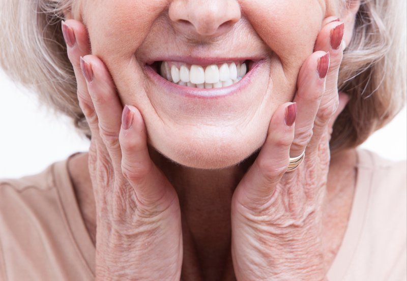 Woman with dentures smiles.